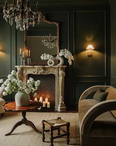 a living room filled with furniture and a chandelier above a fire place in front of a fireplace