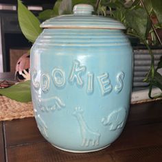 a blue cookie jar sitting on top of a wooden table