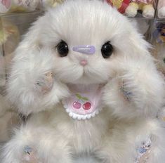 a white stuffed animal sitting on top of a table