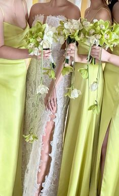 three bridesmaids in lime green dresses with white flowers and greenery on them