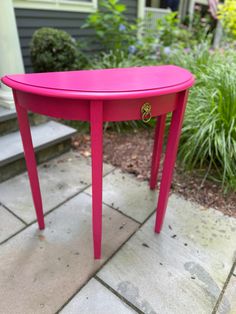 a pink table sitting on top of a patio