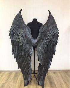 a mannequin with large black wings on it