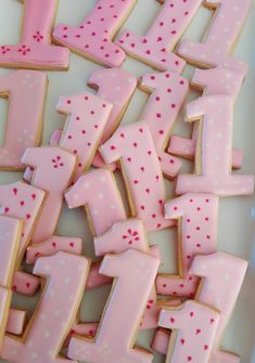 pink and white decorated cookies in the shape of numbers