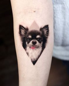 a small dog's face is shown in the shape of a heart with its tongue sticking out