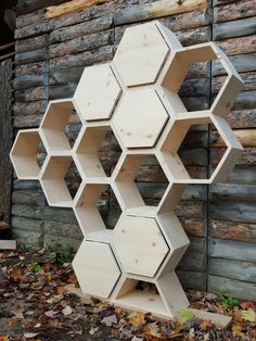 a bunch of hexagons are stacked on top of each other in front of a building