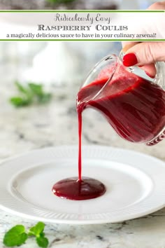 someone pouring red liquid onto a white plate