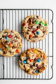 three cookies on a cooling rack with m & m's