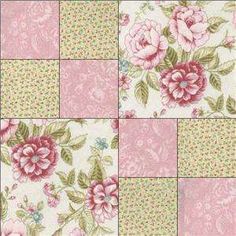 a patchwork quilt with pink flowers and green leaves