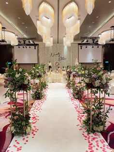 an aisle decorated with flowers and greenery for a wedding reception at the ritz