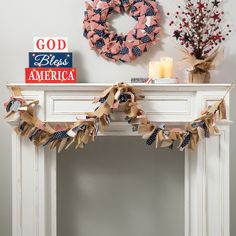 a mantle with wreaths and patriotic decorations on it