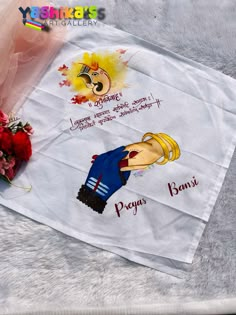 a white towel with cartoon characters on it and flowers in the corner next to it