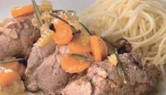 some meat with carrots and noodles on a plate