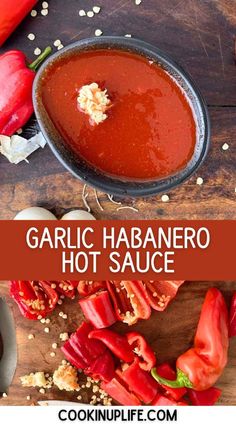 garlic habanero hot sauce in a skillet on a wooden cutting board with red peppers