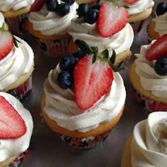 cupcakes with white frosting and strawberries on top