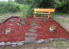 a wooden bench sitting in the middle of a garden