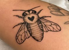 a black and white photo of a bee tattoo