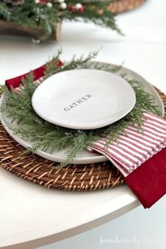 a white plate with red and green napkins on top of it sitting on a wicker place mat