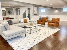 a living room with couches and chairs in it