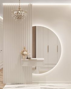 a white bathroom with a chandelier hanging from the ceiling