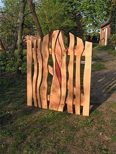 a wooden fence made out of wood with wavy lines on the top and bottom part