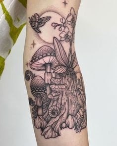 a woman's leg with tattoos on it