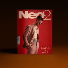 a man in a suit and tie on the cover of neco magazine, looking down at his shirt