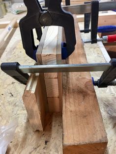 a bench made out of wooden planks with tools attached to the back and sides