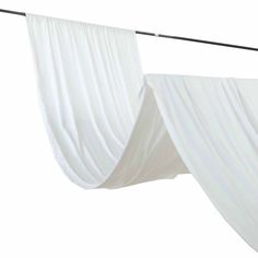 two white drapes hanging from a clothes line