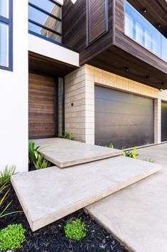 two concrete steps in front of a modern house