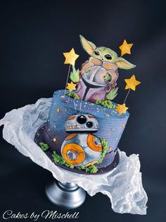 a star wars themed cake with the baby yoda and bb - o - rama on top