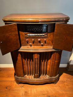 an old radio sitting on top of a wooden cabinet