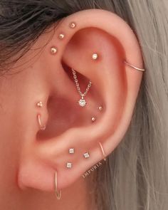 a woman's ear with three different types of piercings on the top and bottom