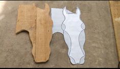 two pieces of wood cut out to look like horses