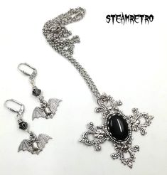 "This fantastic silver plated filigree cross necklace features a Swarovski black jet crystal and is part of our new Dark Gothic range, and is a step away from our previous steampunk work.The set comes complete with our spooky silver plated vampire bat earrings! There are numerous Gothic designers out there, and various marketplaces to purchase Gothic jewellery, but i am sure you will like what we are doing here Growing up in the 80's i lived through the \"goth\" movement, many a lost weekend was Gothic Metal Jewelry With Filigree, Gothic Filigree Metal Jewelry, Antique Silver Gothic Jewelry With Filigree, Antique Silver Gothic Filigree Jewelry, Gothic Antique Silver Filigree Jewelry, Gothic Sterling Silver Filigree Jewelry, Gothic Cross Pendant Jewelry For Halloween, Gothic Cross Jewelry For Gifts, Gothic Metal Cross Pendant Jewelry