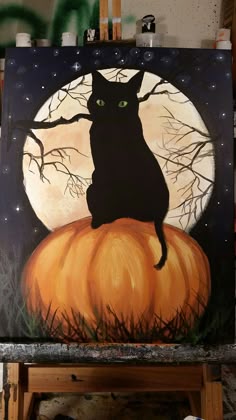 a painting of a black cat sitting on top of a pumpkin