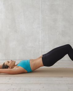 a woman is doing an exercise on her stomach