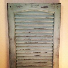 an old window with shutters on the outside and inside is painted light blue in color