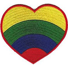 a rainbow heart shaped patch on a white background