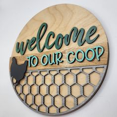 a wooden sign that says welcome to our coop