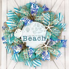 a wreath that says take me to the beach with starfishs and seashells