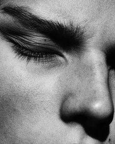 black and white photograph of a man's face with his nose close to the camera