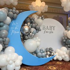 balloons are arranged around the moon for a baby shower