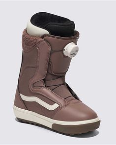 a brown snowboard boot with white trims and a button on the front side