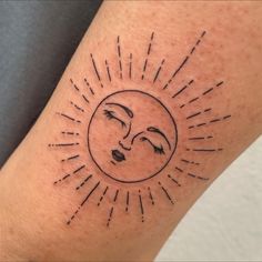 a sun and moon tattoo on the arm