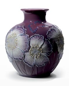 a purple vase with flowers painted on it