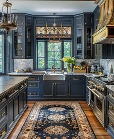 a kitchen with blue cabinets and an area rug