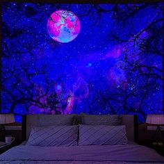 a bed sitting under a purple sky filled with stars and a full moon above it