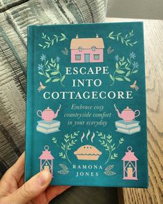 a person holding up a book about escape into cottage