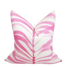 a pink and white zebra print pillow on a white background