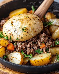 a skillet filled with potatoes, meat and spices